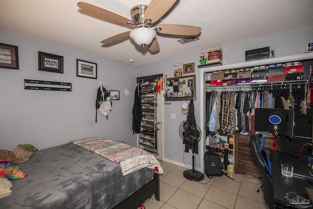 tiled bedroom with a ceiling fan, a textured ceiling, and visible vents