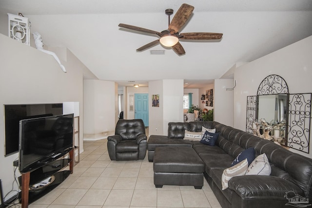 living area with light tile patterned floors, ceiling fan, vaulted ceiling, and visible vents
