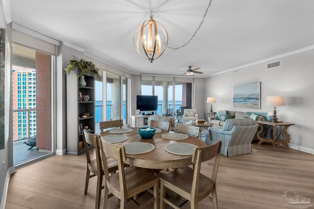 dining space featuring ornamental molding, ceiling fan with notable chandelier, and light hardwood / wood-style flooring