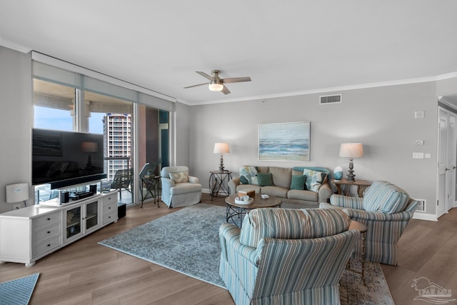 living room with crown molding, a wall of windows, ceiling fan, and light hardwood / wood-style floors