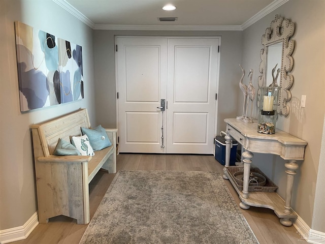 interior space featuring crown molding and light hardwood / wood-style flooring