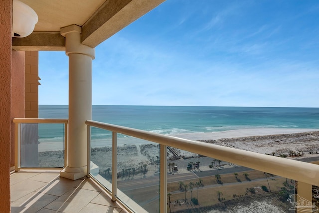 balcony featuring a water view and a beach view