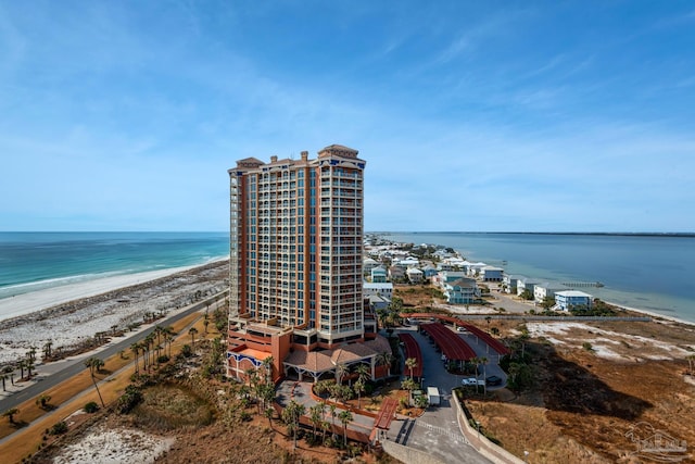 birds eye view of property with a view of the beach and a water view