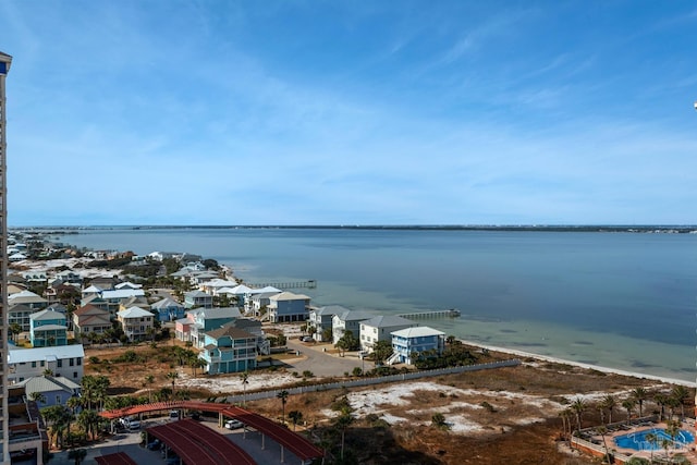 drone / aerial view featuring a beach view and a water view