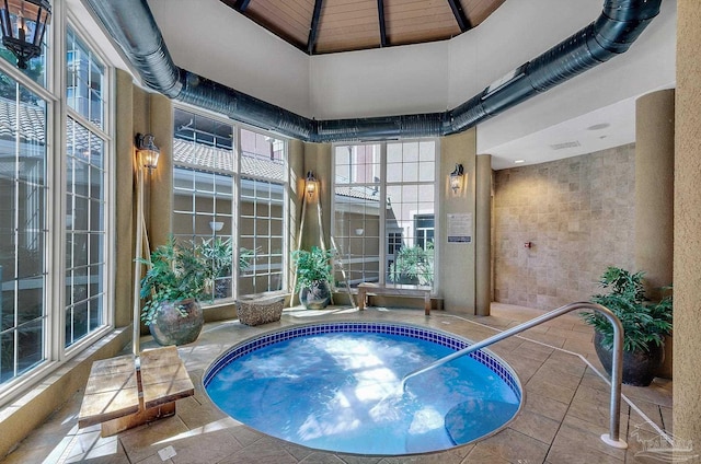 view of swimming pool with an indoor in ground hot tub