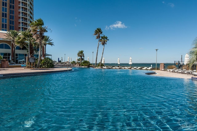 view of swimming pool with a water view