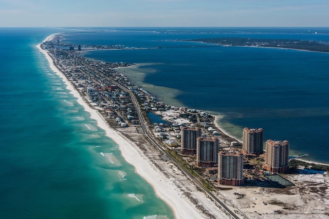 birds eye view of property featuring a water view and a beach view