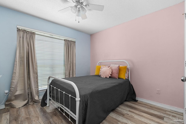 28 Easton St, Cantonment, FL 32533 - bedroom with wood finished floors, a ceiling fan, a textured ceiling, and baseboards