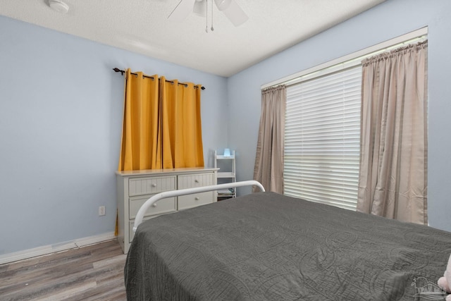 28 Easton St, Cantonment, FL 32533 - bedroom with wood finished floors, a ceiling fan, and baseboards