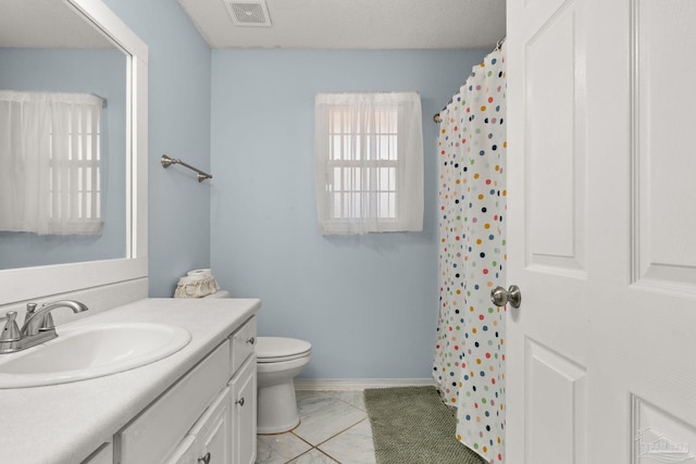 28 Easton St, Cantonment, FL 32533 - bathroom featuring vanity, toilet, baseboards, and a shower with shower curtain