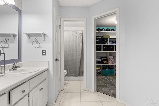 28 Easton St, Cantonment, FL 32533 - full bathroom featuring toilet, tile patterned floors, vanity, a walk in closet, and curtained shower
