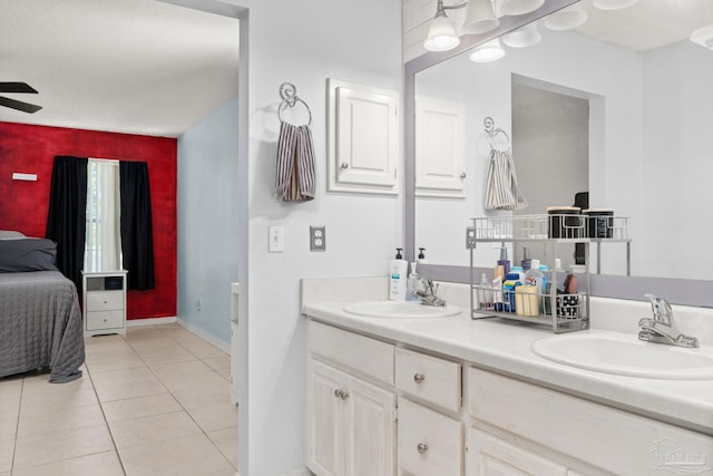 28 Easton St, Cantonment, FL 32533 - bathroom with double vanity, tile patterned floors, ensuite bathroom, ceiling fan, and baseboards