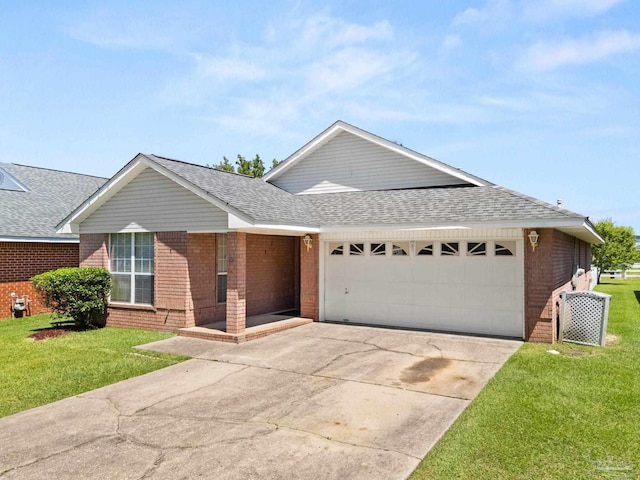 28 Easton St, Cantonment, FL 32533 - ranch-style home with brick siding, a garage, a shingled roof, driveway, and a front lawn