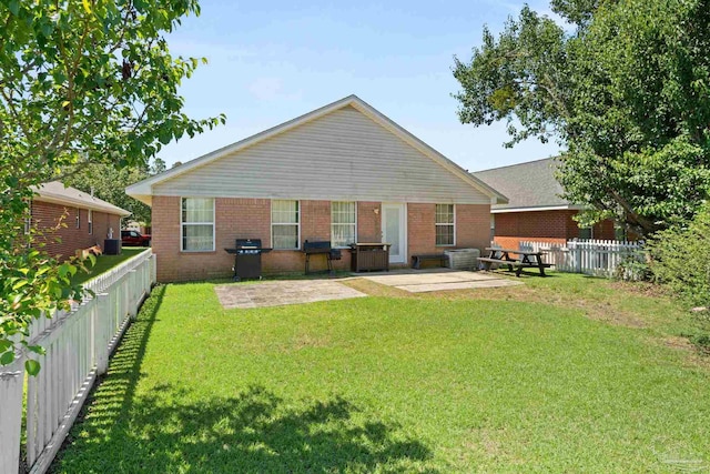 28 Easton St, Cantonment, FL 32533 - rear view of house with a patio and brick siding