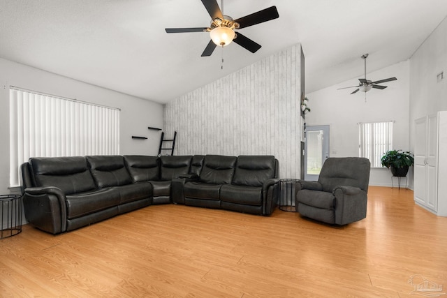 28 Easton St, Cantonment, FL 32533 - living room featuring ceiling fan, an accent wall, lofted ceiling, wallpapered walls, and light wood-style flooring