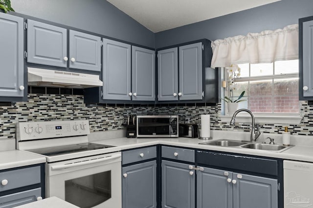28 Easton St, Cantonment, FL 32533 - kitchen with white appliances, under cabinet range hood, a sink, backsplash, and light countertops