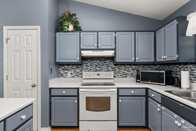 28 Easton St, Cantonment, FL 32533 - kitchen with electric stove, stainless steel microwave, under cabinet range hood, gray cabinets, and lofted ceiling