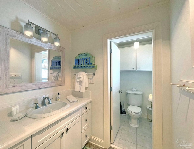 1207 Ariola Dr, Pensacola Beach, FL 32561 - bathroom featuring ornamental molding, toilet, tile patterned floors, and vanity