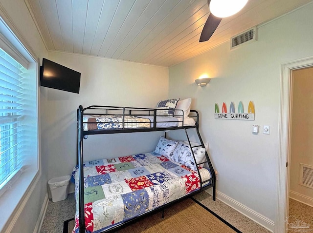 1207 Ariola Dr, Pensacola Beach, FL 32561 - carpeted bedroom with multiple windows, a ceiling fan, wood ceiling, and baseboards