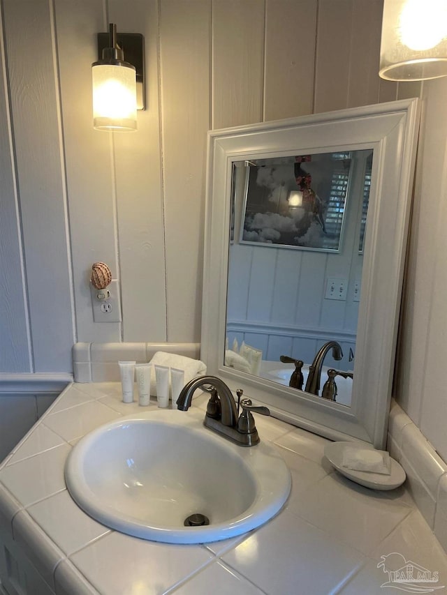 1207 Ariola Dr, Pensacola Beach, FL 32561 - bathroom with a decorative wall and vanity