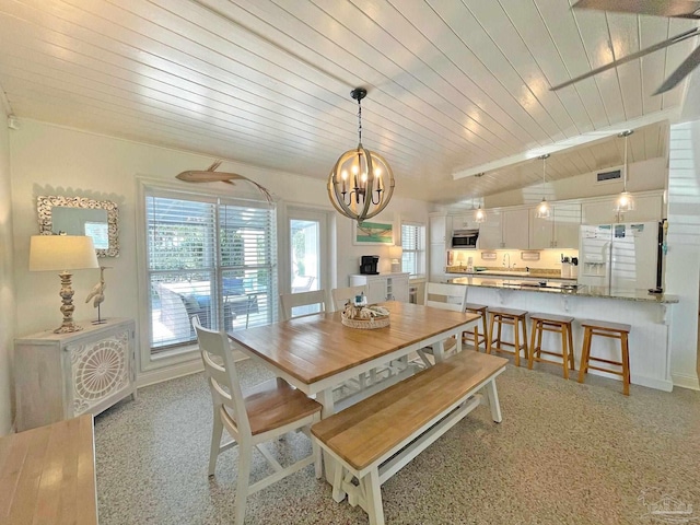 1207 Ariola Dr, Pensacola Beach, FL 32561 - dining space with a chandelier, wooden ceiling, baseboards, and dark speckled floor