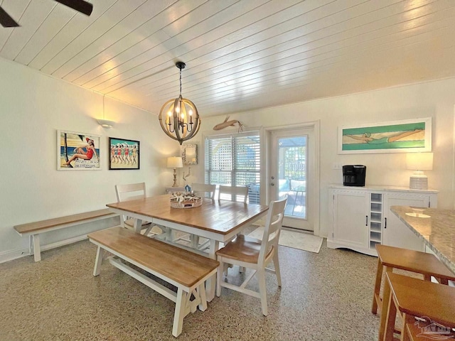 1207 Ariola Dr, Pensacola Beach, FL 32561 - dining area with a chandelier, wood ceiling, and dark speckled floor