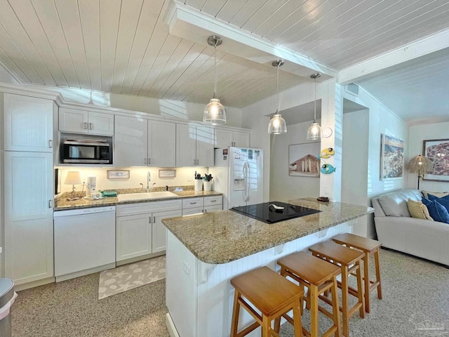 1207 Ariola Dr, Pensacola Beach, FL 32561 - kitchen featuring white appliances, a sink, wood ceiling, a breakfast bar area, and open floor plan