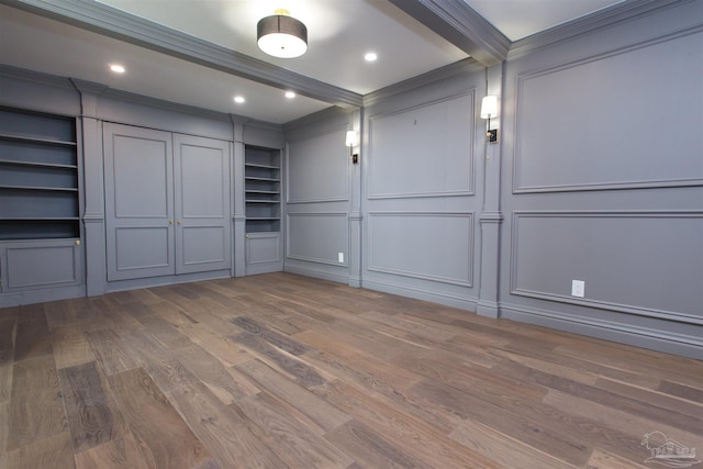 interior space with ornamental molding and wood-type flooring