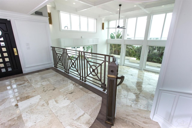 stairway with ornamental molding, beamed ceiling, and coffered ceiling