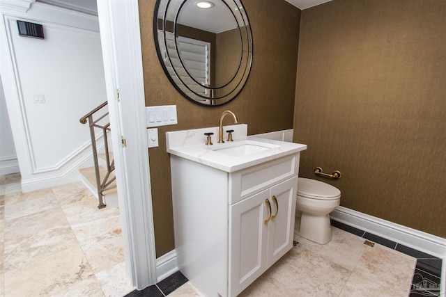 bathroom with toilet and vanity