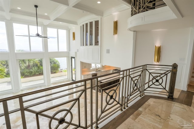 hallway with ornamental molding, hardwood / wood-style floors, beam ceiling, and coffered ceiling