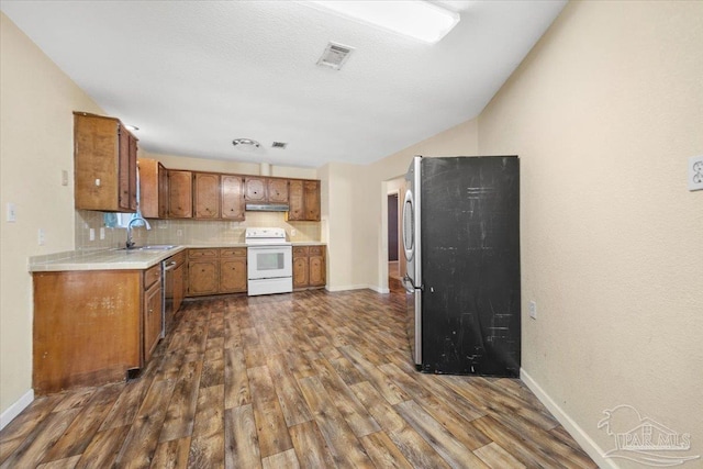 kitchen featuring decorative backsplash, dark hardwood / wood-style flooring, sink, and appliances with stainless steel finishes