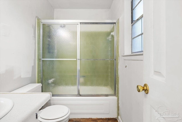 full bathroom with vanity, toilet, and shower / bath combination with glass door