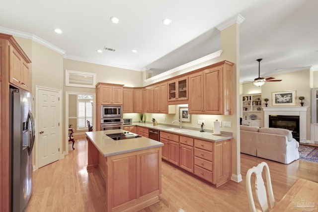 kitchen featuring visible vents, crown molding, light countertops, stainless steel appliances, and a sink