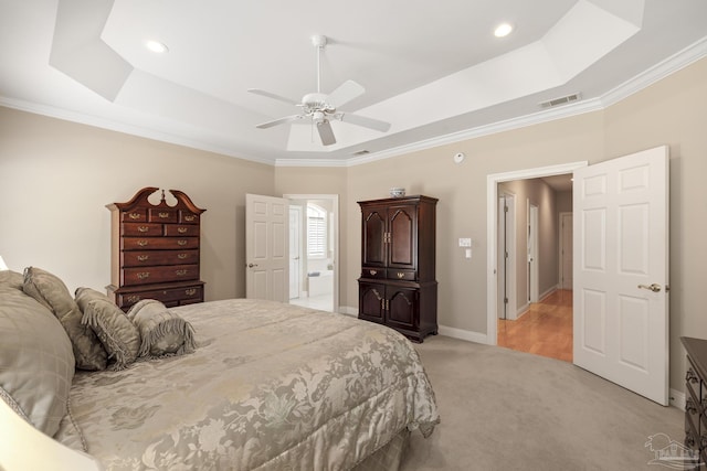 bedroom with baseboards, visible vents, a tray ceiling, crown molding, and light colored carpet