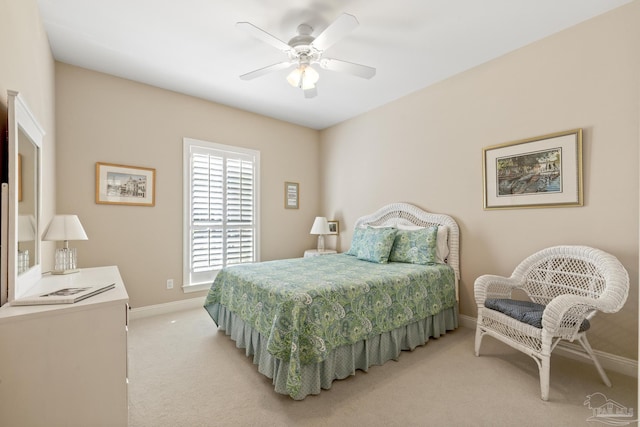 bedroom with light carpet, ceiling fan, and baseboards