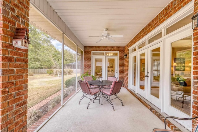 sunroom / solarium featuring french doors and ceiling fan