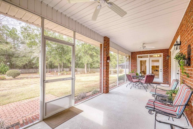 sunroom / solarium featuring a ceiling fan