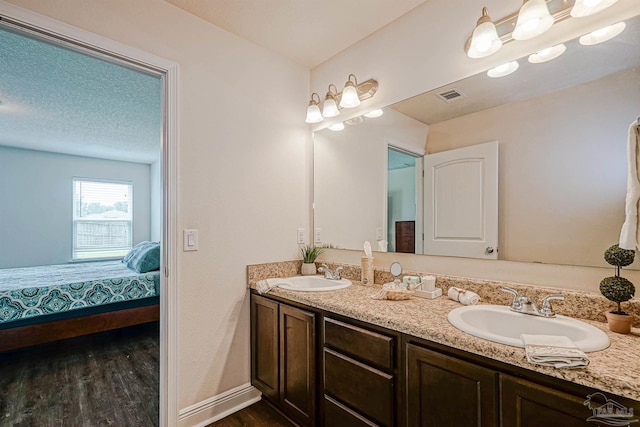 257 Millet Cir, Cantonment, FL 32533 - full bath featuring visible vents, a sink, wood finished floors, and double vanity