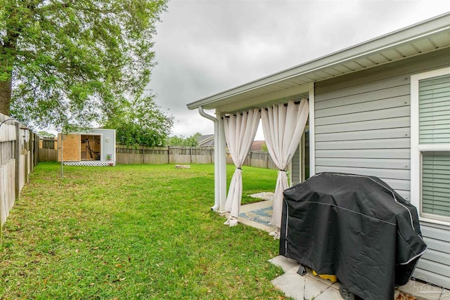 257 Millet Cir, Cantonment, FL 32533 - view of yard with an outdoor structure, a fenced backyard, and a shed
