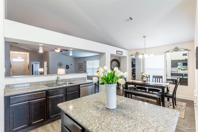 257 Millet Cir, Cantonment, FL 32533 - kitchen with visible vents, dishwasher, a sink, lofted ceiling, and light wood-style flooring