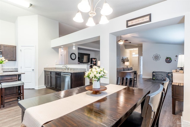 257 Millet Cir, Cantonment, FL 32533 - dining area with vaulted ceiling, baseboards, ceiling fan with notable chandelier, and light wood finished floors