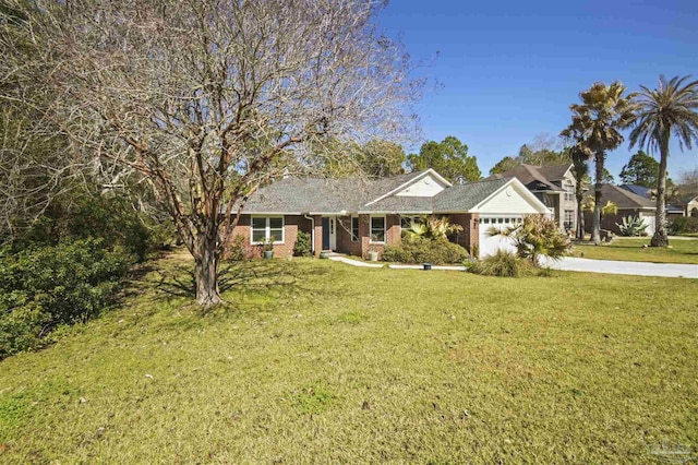 single story home with an attached garage, driveway, brick siding, and a front yard