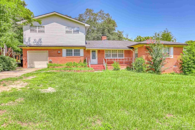 view of front of home with a garage and a front lawn