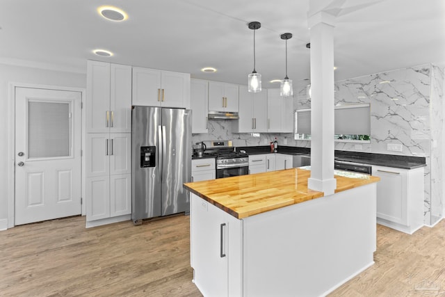 kitchen featuring wooden counters, light hardwood / wood-style flooring, tasteful backsplash, and stainless steel appliances