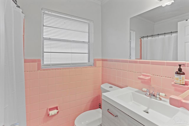 bathroom featuring tasteful backsplash, tile walls, toilet, vanity, and ornamental molding