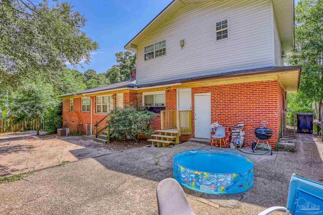 rear view of property with central AC and a patio area