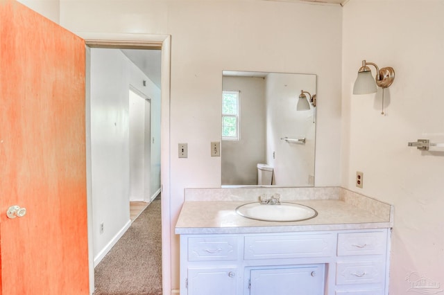 bathroom featuring toilet and vanity