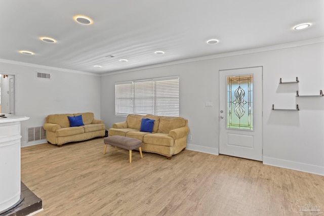 living room featuring light wood-type flooring and ornamental molding