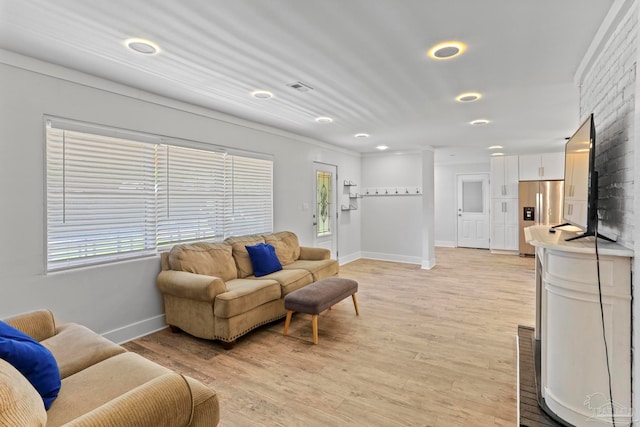 living room with a wealth of natural light and light wood-type flooring